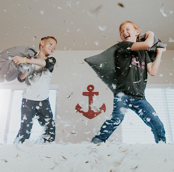 Children having fun with a pillow fight children having fun after overcoming anxiety