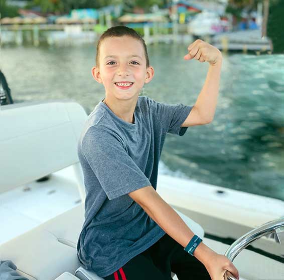 Greyson driving a boat-apraxia success story