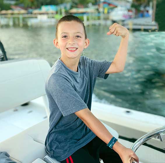 Greyson-driving-a-boat-copy Greyson driving a boat-apraxia success story
